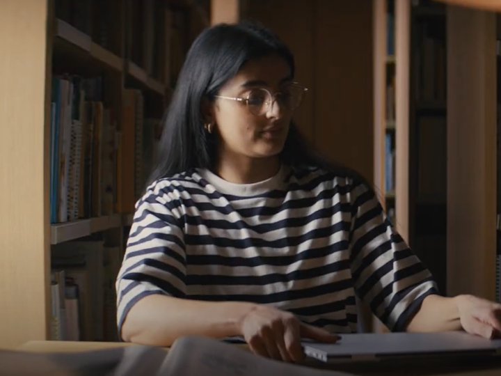still from the commercial. The archeologitst student the library.