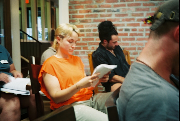 A DAY IN THE LIFE - Cast members reading along with the script during rehearsal.