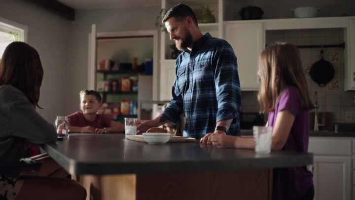 father with kids children in kitchen talking and smiling