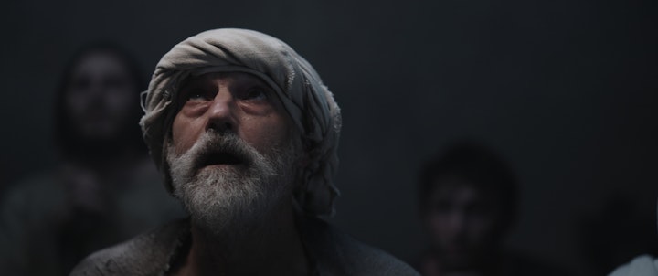 jewish christian man looks up dimly lit room mouth open ajar and eyes in wonder
