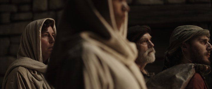 woman in jewish synagogue looks in wonder in crowd wearing robes and ancient clothes