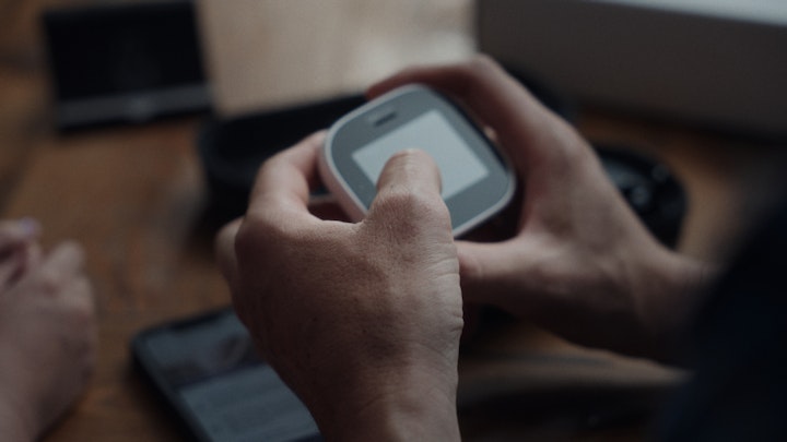 close up of hand using medical device touching screen with fingers
