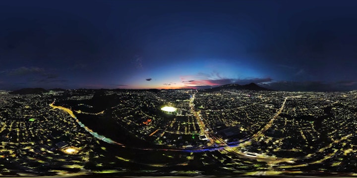 The city of San Salvador right after dusk on a panoramic shot taken from above.