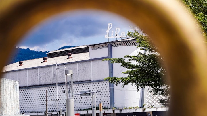 An old cinema in downtown San Salvador awaits its revival. The image plays with angles and depth of field to create a dynamic view, capturing the essence of its former glory and the surrounding area from a bygone era."