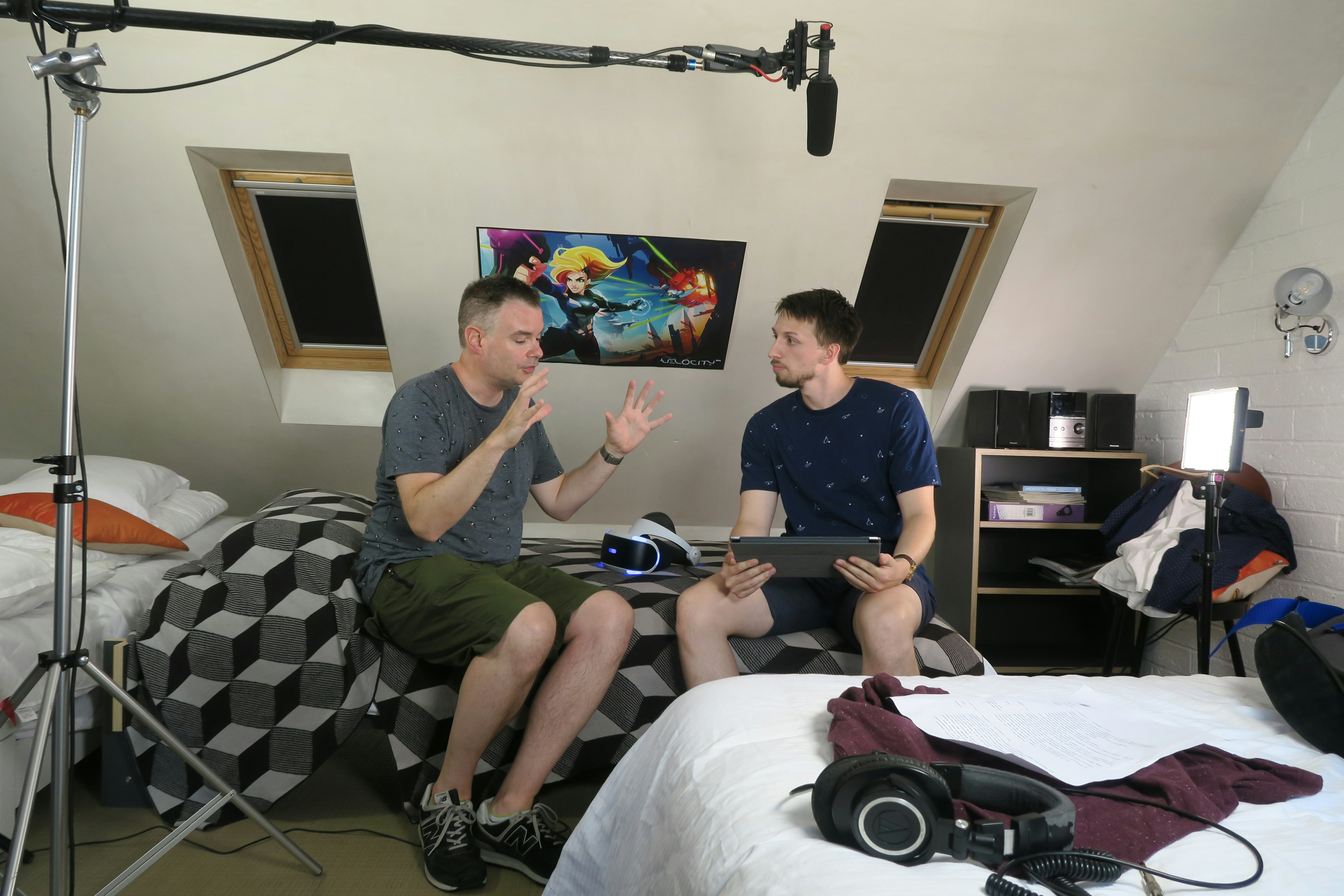 Game and UI artist Paul Simpson describbes the new Futurlab Sony Playstation VR game to actor Adam Leadbitter, behind the scenes on the Big Egg Futurlab trailer shoot