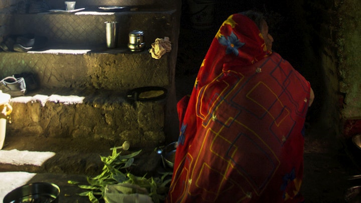 Early morning. Women prepared cooking on a chulha, a traditional stove heated by firewood or dry cow dung cakes.<br> It is commonly used for cooking and heating food in rural households.
