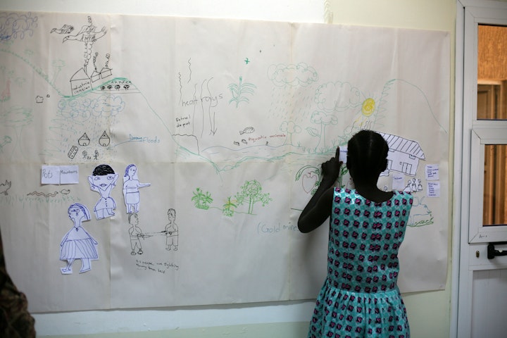 The drawing shows school on the right and girls at home on the left. Photo: Josie Gallo