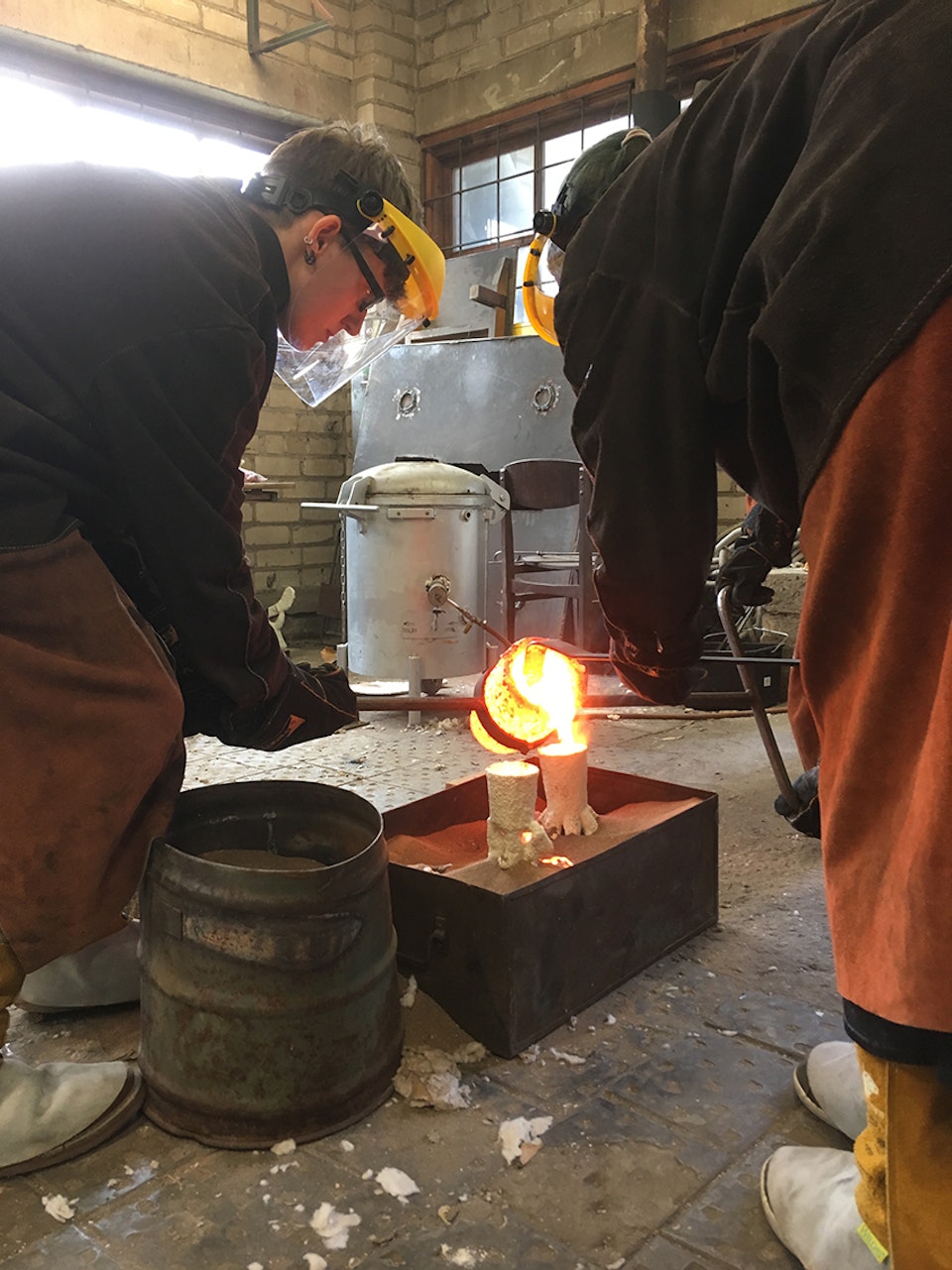 Alchemical Bronze Casting - Students pouring, drossing