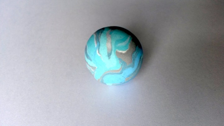 Resultant clūd (marble) made from polymer clay.