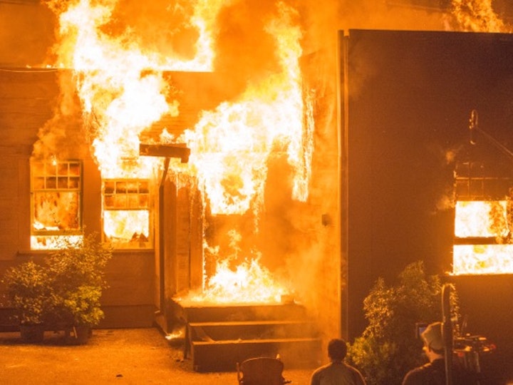 Exterior house replica set on fire
