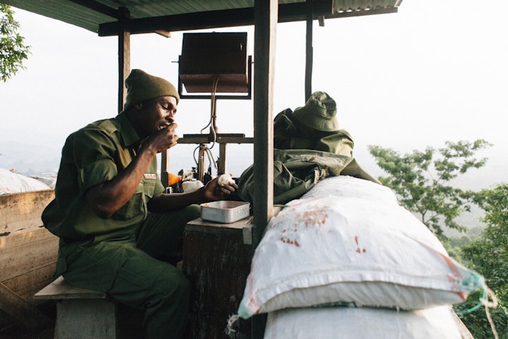 A Virunga Ranger has dinner at his watch post. Virunga National Park. Rutshuru.