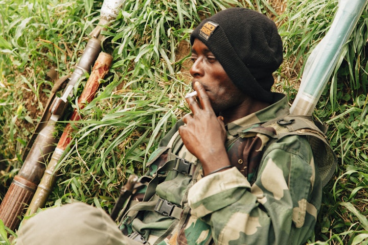 A FARDC soldier smokes, close to the Masisi front line.