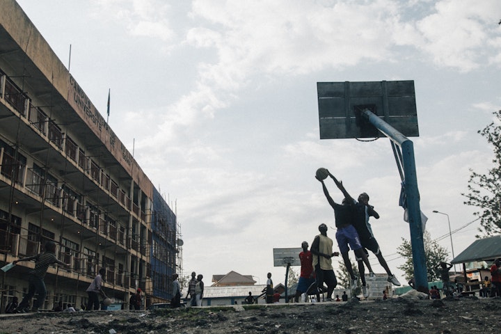 Daily life in Goma. Boys play basketball in front of Goma University.